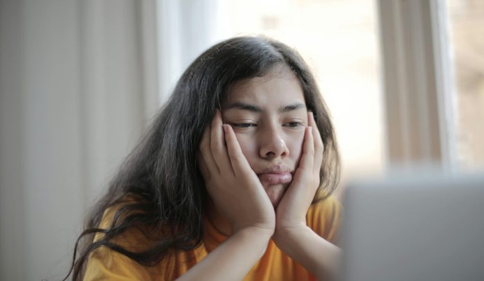 Unimpressed-woman-looking-at-laptop-screen